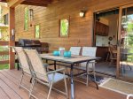 Deck accessed from dining room with ample seating, hot tub, and gas grill